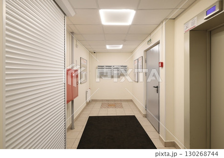 A modern office hallway featuring convenient elevator access for easy navigation and mobility A modern office hallway featuring convenient elevator access for easy navigation and mobility 130268744