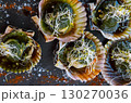 Delicious grilled scallops in shells, fresh seafood with a sause and soy sprouts. 130270036