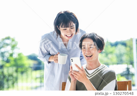 スマホで検索をする夫婦 130270548
