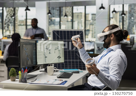 Engineer uses VR headset to optimize sustainable solar panel fabrication with advanced assembly lines. Clean energy expert innovates solar manufacturing processes using virtual reality simulation 130270750