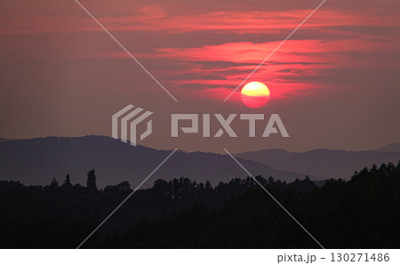 真っ赤に染まった空と沈みゆく太陽のイメージ風景 130271486