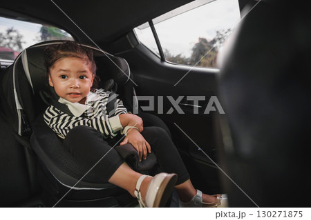 happy toddler girl sitting in car seat, safety baby chair travelling happy toddler girl sitting in car seat, safety baby chair travelling 130271875