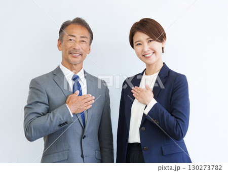 胸に手を当てるカメラ目線のビジネスマン男女 130273782