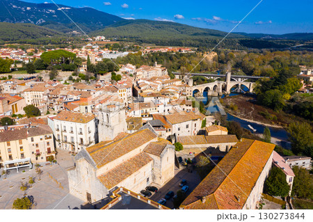 View from drone of Besalu with arched bridge over Fluvia river 130273844