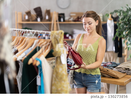 Young women choosing handbag in store 130273856