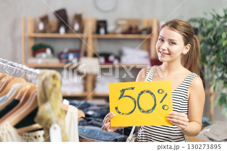 Woman holding poster with 50 discount Woman holding poster with 50 discount 130273895
