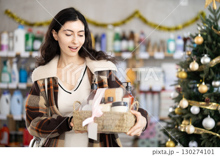 Woman choosing a gift set for the new year Woman choosing a gift set for the new year 130274101