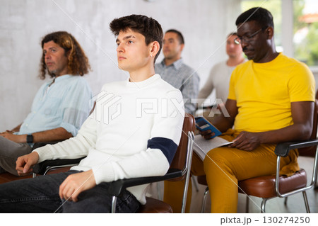 Group of men listening to lecture in auditorium attentively Group of men listening to lecture in auditorium attentively 130274250