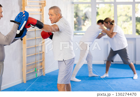Two men training boxing fight in studio Two men training boxing fight in studio 130274470