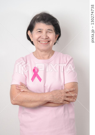 Elderly woman with pink Ribbon for Pink October Breast Cancer Awareness month, May Women Health, February World cancer day, support people life and illness. National cancer survivors month 130274738