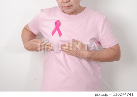 Elderly woman with pink Ribbon for Pink October Breast Cancer Awareness month, May Women Health, February World cancer day, support people life and illness. National cancer survivors month Elderly woman with pink Ribbon for Pink October Breast Cancer Awareness month, May Women Health, February World cancer day, support people life and illness. National cancer survivors month 130274741