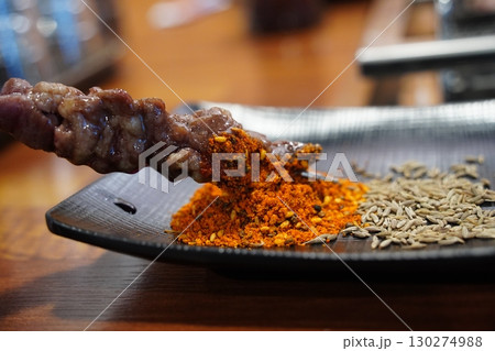 Lamb Skewer with Seasoning on a Black Plate Lamb Skewer with Seasoning on a Black Plate 130274988