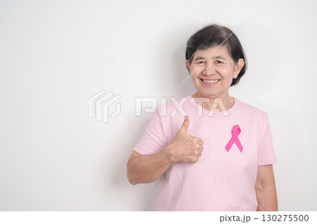 Elderly woman with pink Ribbon for Pink October Breast Cancer Awareness month, May Women Health, August World Breastfeeding week, Nursing Mothers, Pregnancy and Infant Loss Remembrance, Stillbirth 130275500