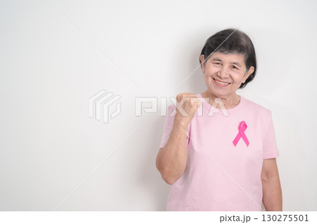 Elderly woman with pink Ribbon for Pink October Breast Cancer Awareness month, May Women Health, August World Breastfeeding week, Nursing Mothers, Pregnancy and Infant Loss Remembrance, Stillbirth 130275501