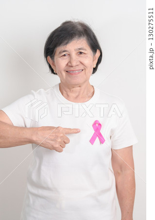 Elderly woman with pink Ribbon for Pink October Breast Cancer Awareness month, May Women Health, August World Breastfeeding week, Nursing Mothers, Pregnancy and Infant Loss Remembrance, Stillbirth 130275511