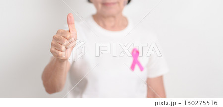 Elderly woman with pink Ribbon for Pink October Breast Cancer Awareness month, May Women Health, August World Breastfeeding week, Nursing Mothers, Pregnancy and Infant Loss Remembrance, Stillbirth 130275516