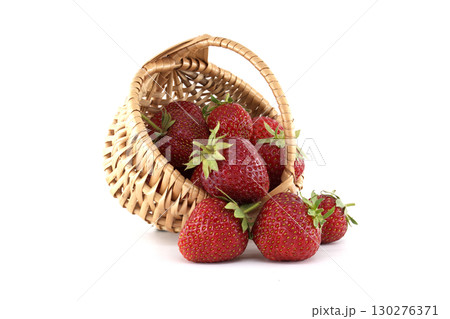 Wicker basket spilling fresh strawberries on white background 130276371