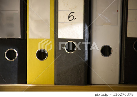 The image shows a close-up of several ring binder folders, neatly arranged and ready for use. The image shows a close-up of several ring binder folders, neatly arranged and ready for use. 130276379