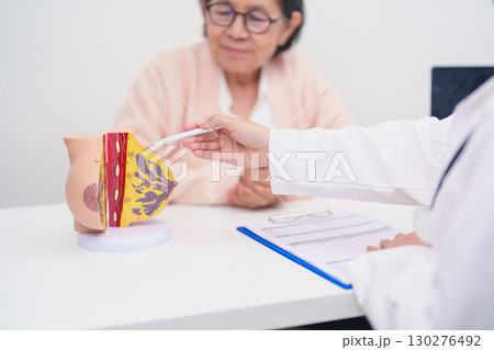 Elderly woman Patient consultation with doctor for Breast Augmentation Surgery, October Breast Cancer Awareness month, implant, Diagnosis, Beauty woman enlargement and medical healthcare concept 130276492