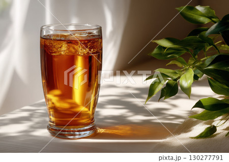 Refreshing iced tea glass on a bright surface with shadows 130277791