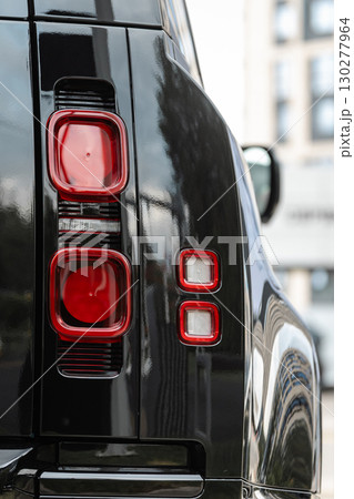 Close-up detail of the rear tail light on a modern black SUV. Close-up detail of the rear tail light on a modern black SUV. 130277964