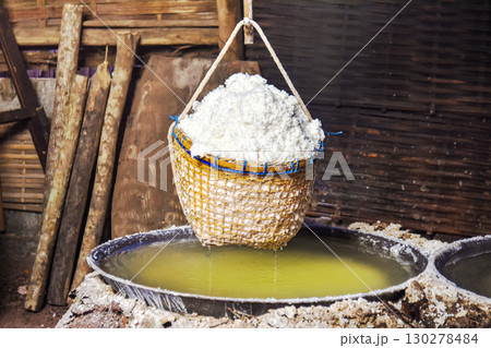 Traditional salt production with woven bamboo basket filled in rural workshop Traditional salt production with woven bamboo basket filled in rural workshop 130278484