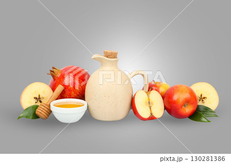 Fresh apples are arranged with honey and a decorative jug 130281386