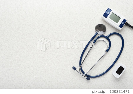 Healthcare medical background of stethoscope blood pressure monitor and pulse oximeter flat lay on table with copy-space Healthcare medical background of stethoscope blood pressure monitor and pulse oximeter flat lay on table with copy-space 130281471