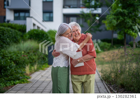 Portrait of beautiful adult daughter with old mother. 130282361