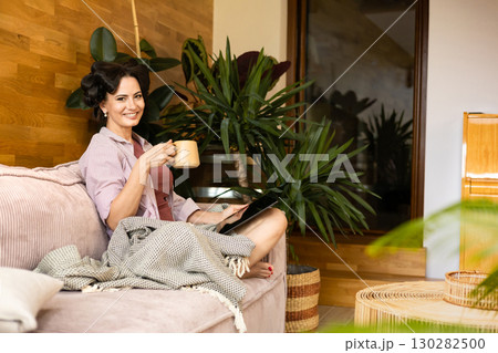 Portrait of woman with hair rollers during slow morning. 130282500