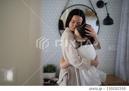 Mom hugging daughter during emotional conversation Mom hugging daughter during emotional conversation 130282508
