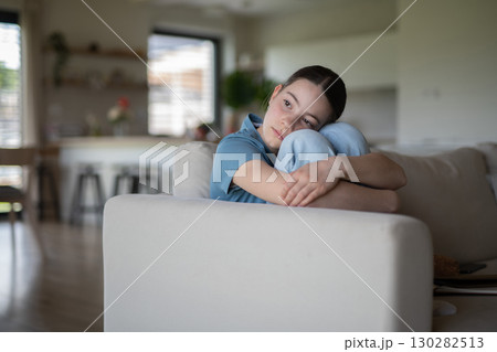 Teenage girl struggling with emotions in living room. Teenage girl struggling with emotions in living room. 130282513