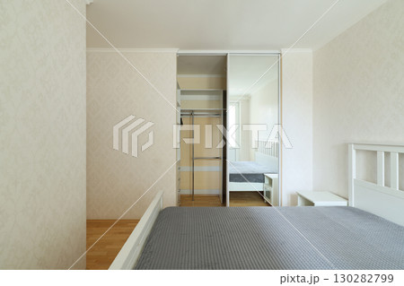 A beautifully designed Modern Minimalist Bedroom with a wardrobe and ample natural light A beautifully designed Modern Minimalist Bedroom with a wardrobe and ample natural light 130282799