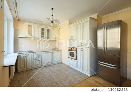 This modern kitchen interior features stunning stainless steel appliances and elegant design 130282838