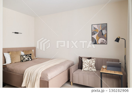 A Modern Minimalist Bedroom that Features Stylish Decor and a Cozy, Inviting Atmosphere A Modern Minimalist Bedroom that Features Stylish Decor and a Cozy, Inviting Atmosphere 130282906