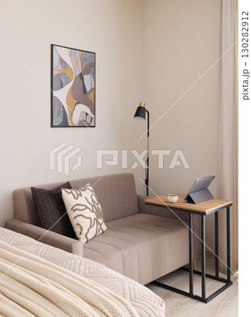 A Cozy and Modern Living Space That Features Art, Comfort, and a Functional Workspace A Cozy and Modern Living Space That Features Art, Comfort, and a Functional Workspace 130282912