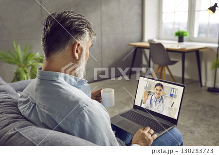 Senior man using laptop and having medical consultation with doctor via video call Senior man using laptop and having medical consultation with doctor via video call 130283723