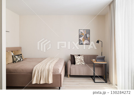 A stylish Modern Minimalist Bedroom featuring a Cozy Seating Area for relaxation and comfort 130284272