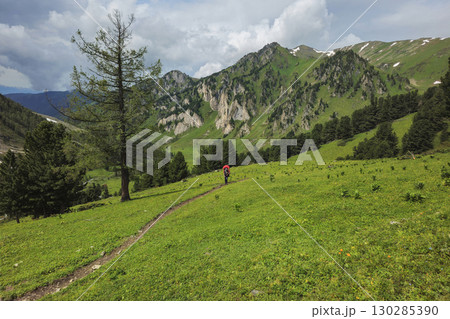 Male tourist to the distance with large backpack Male tourist to the distance with large backpack 130285390