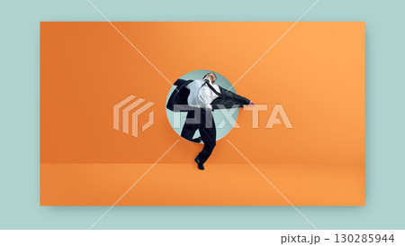 Creative composition. Businessman stretching through round doorway on orange wall with expressive motion and stylish suit Creative composition. Businessman stretching through round doorway on orange wall with expressive motion and stylish suit 130285944