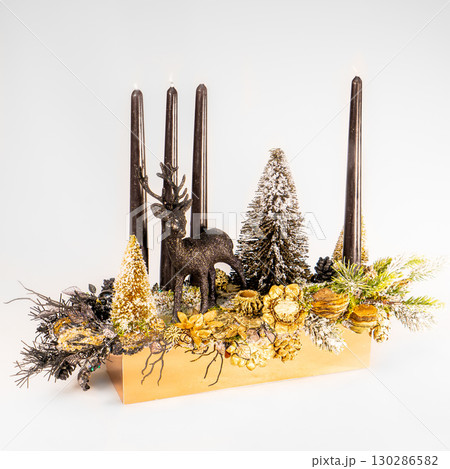 Christmas table composition. Beautiful decoration. Christmas trees, candles, stars, lights and elegant accessories. Merry Christmas and Happy Holidays, Template. 130286582