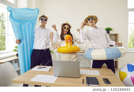 Happy corporate business team going on summer vacation and having fun in the office 130286691