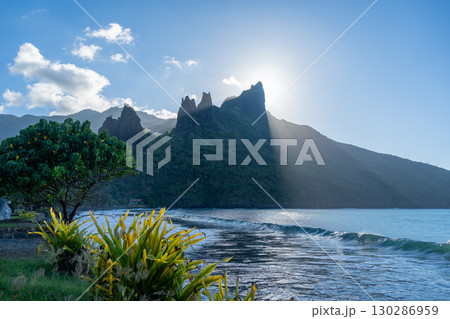 Sunset over Hatiheu Bay and beach in Nuku Hiva, French Polynesia Sunset over Hatiheu Bay and beach in Nuku Hiva, French Polynesia 130286959