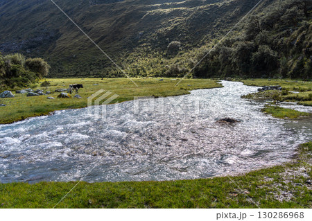 River and snow-capped mountains along the Laguna 69 trek in Huaraz, Peru 130286968