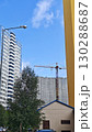 High-rise apartment buildings with a construction crane in the background under a clear blue sky. The image reflects modern urban development and residential infrastructure growth 130288687