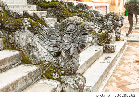Intricately carved stone dragon sculptures on stair railing in Hue Imperial City Vietnam 130289262
