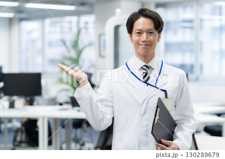 研究所で実験をする白衣の若い男性研究者 130289679