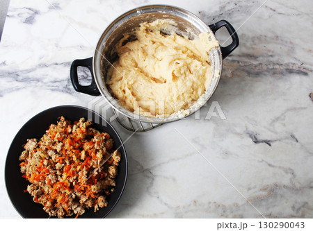 mashed potatoes and minced meat in a plate. Cooking shepherd's pie of potato zraz. Top view 130290043