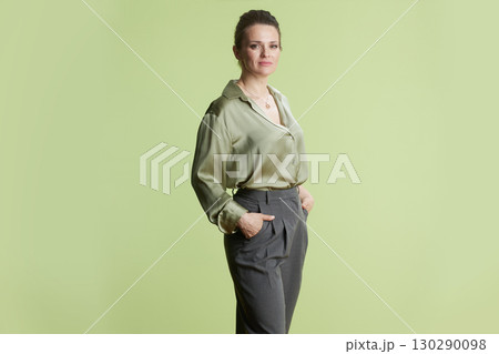 Simple Elegance: Woman in Green Satin Blouse Simple Elegance: Woman in Green Satin Blouse 130290098