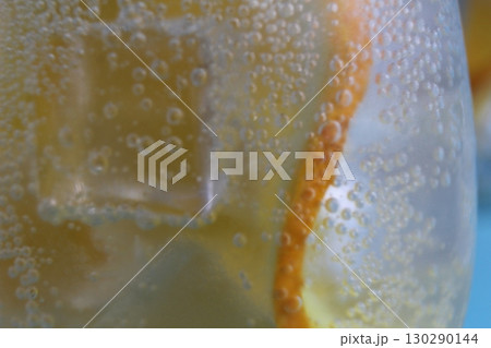 Lemonade water divorcing in a glass of ice and orange is very close-up. Macrophoto Lemonade water divorcing in a glass of ice and orange is very close-up. Macrophoto 130290144